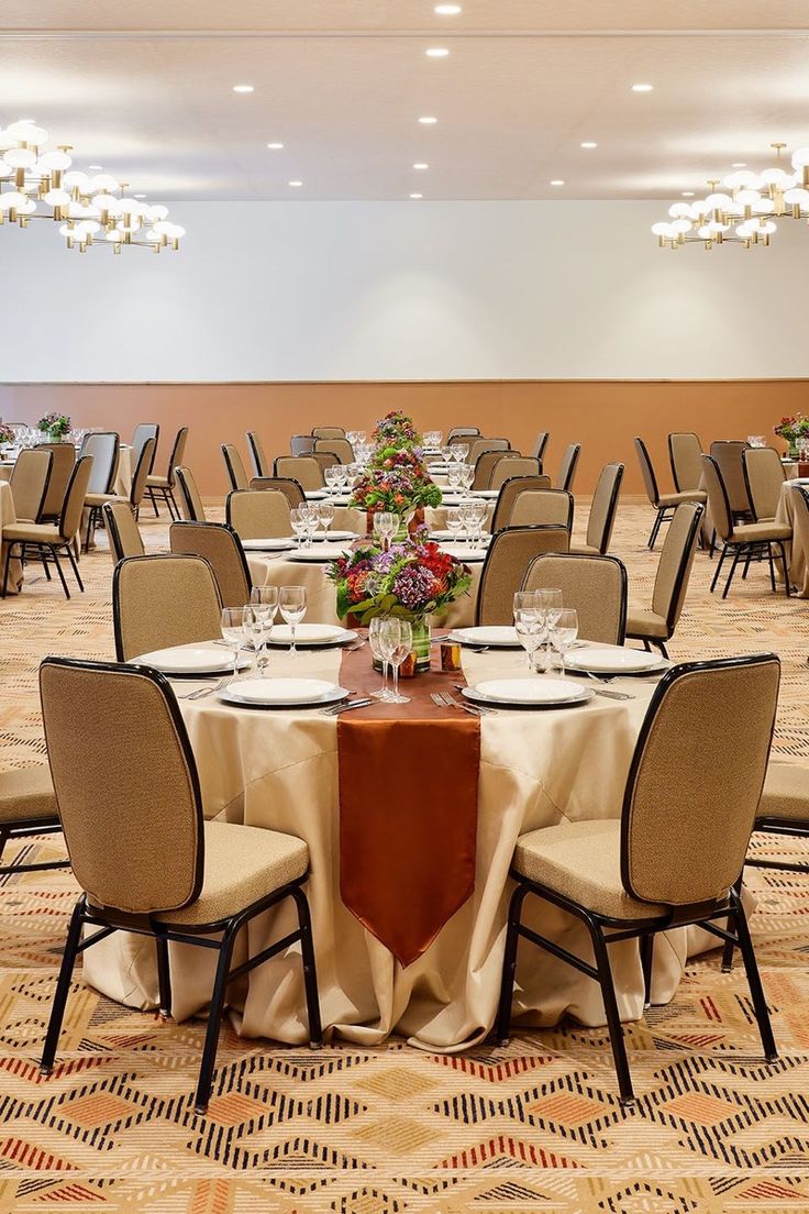 Upholstered stacking banquet chairs around a round banquet table